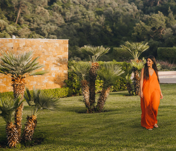 Woman walking next to the small trees