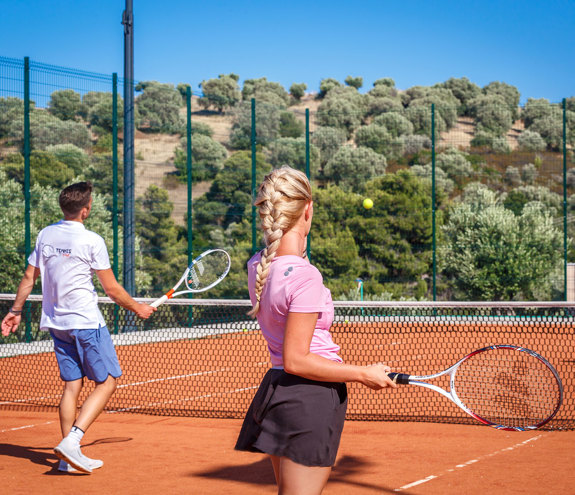 Team playing tennis at the Miraggio tennis court